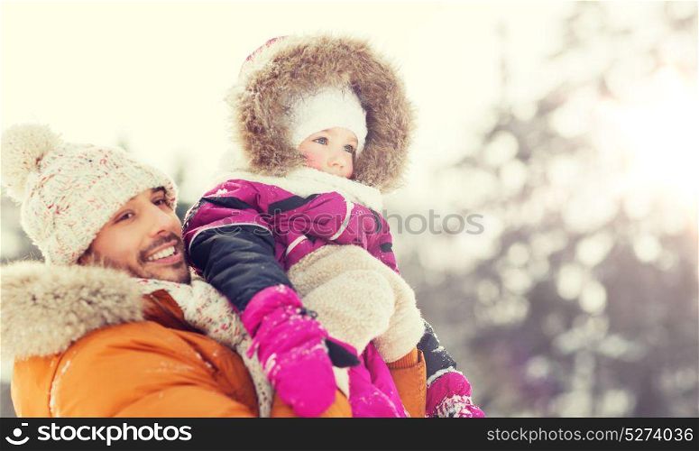 family, parenthood, fatherhood, season and people concept - happy smiling father and little girl in winter clothes outdoors. happy family in winter clothes outdoors