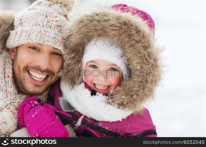 family, parenthood, fatherhood, season and people concept - happy smiling father and little girl in winter clothes outdoors