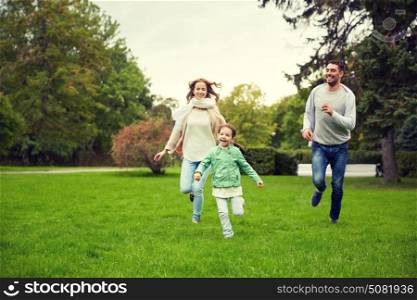 family, parenthood, leisure and people concept - happy mother, father and little girl running and playing catch game in summer park. happy family walking in summer park