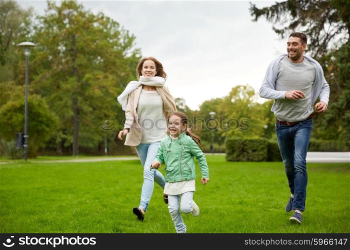 family, parenthood, leisure and people concept - happy mother, father and little girl running and playing catch game in summer park
