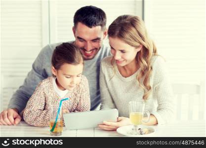 family, parenthood, technology and people concept - happy mother, father and little girl with tablet pc computer having dinner at restaurant