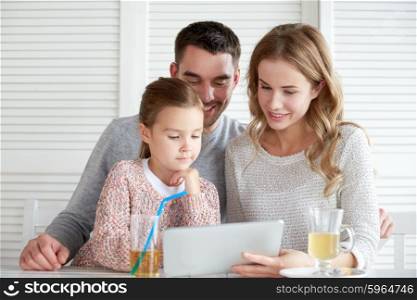 family, parenthood, technology and people concept - happy mother, father and little girl with tablet pc computer having dinner at restaurant