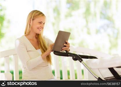 family, parenthood, technology and people concept - happy mother with with tablet pc computer and baby stroller in park