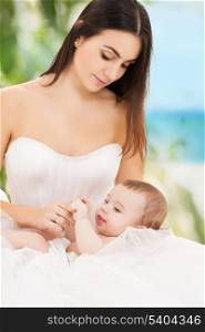 family, parenting and child care concept - happy mother in bridal dress with adorable baby