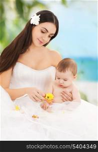 family, parenting and child care concept - happy mother in bridal dress with adorable baby