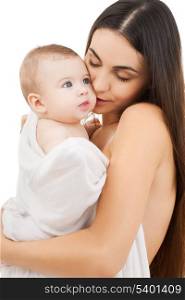 family, parenting and child care concept - happy mother kissing adorable baby