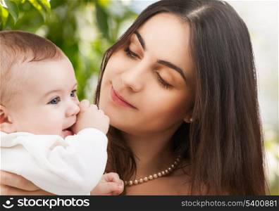 family, parenting and child care concept - happy mother with adorable baby.