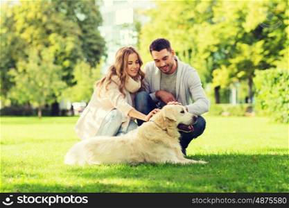 family, pet, animal and people concept - happy couple with labrador retriever dog walking in city park