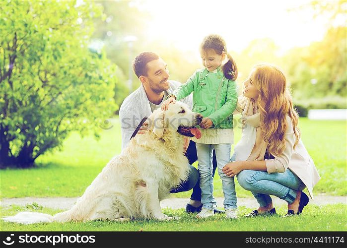 family, pet, domestic animal and people concept - happy family with labrador retriever dog on walk in summer park