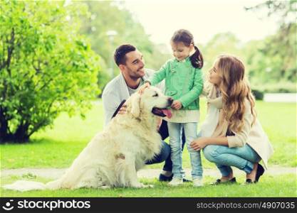 family, pet, domestic animal and people concept - happy family with labrador retriever dog on walk in summer park. happy family with labrador retriever dog in park