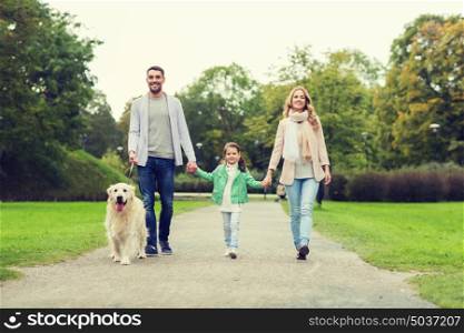 family, pet, domestic animal and people concept - happy family with labrador retriever dog walking in summer park. happy family with labrador retriever dog in park