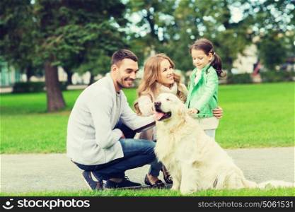 family, pet, domestic animal and people concept - happy family with labrador retriever dog on walk in summer park. happy family with labrador retriever dog in park