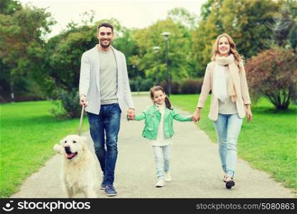 family, pet, domestic animal and people concept - happy family with labrador retriever dog walking in summer park. happy family with labrador retriever dog in park