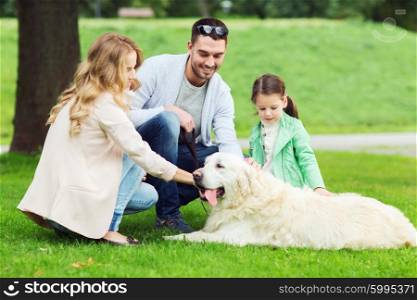 family, pet, domestic animal and people concept - happy family with labrador retriever dog on walk in summer park