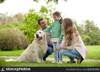 family, pet, domestic animal and people concept - happy family with labrador retriever dog on walk in park