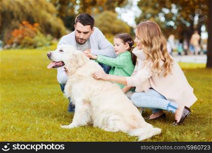 family, pet, domestic animal, season and people concept - happy family with labrador retriever dog on walk in autumn park