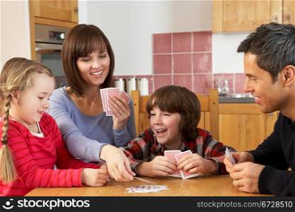 Family Playing Cards In Kitchen