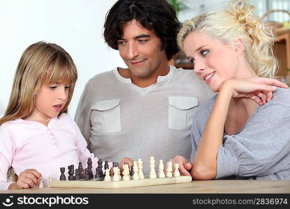 Family playing chess together