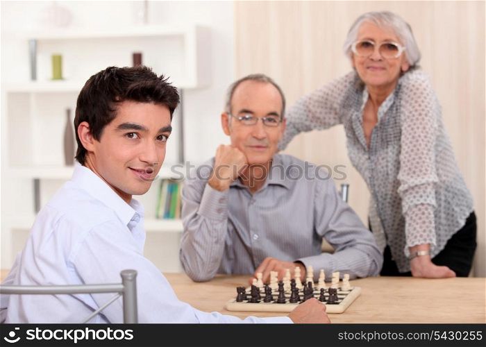 Family playing chess together