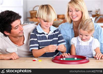 Family playing game at kitchen table