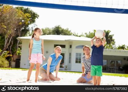 Family Playing Game Of Volleyball In Garden
