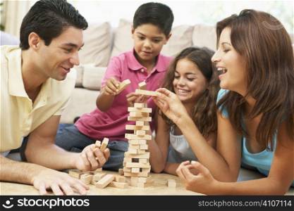 Family Playing Game Together At Home