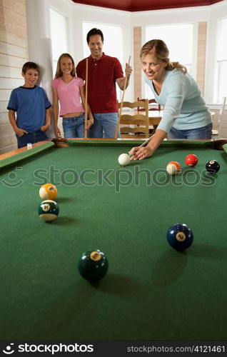 Family Playing Pool in Rec Room