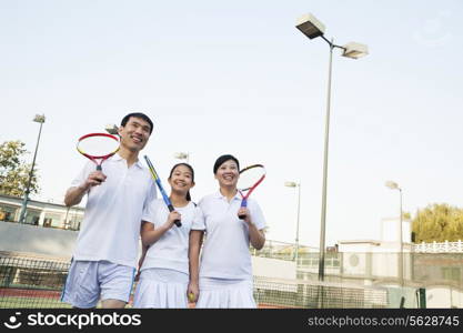 Family playing tennis, portrait