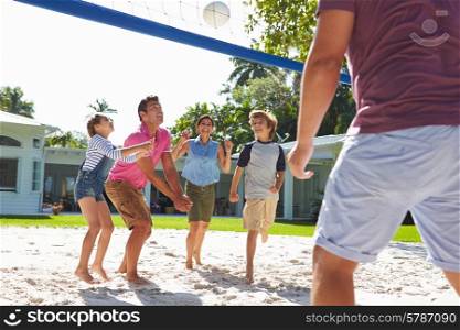 Family Playing Volleyball In Garden At Home