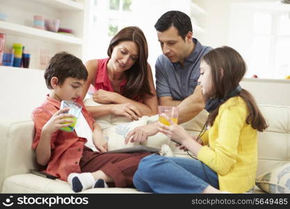 Family Playing With Digital Tablet And MP3 Player