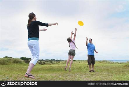 Family playing with flying disc outdoors