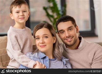 family, portrait and people concept - happy little son with mother and father at home. happy family portrait at home