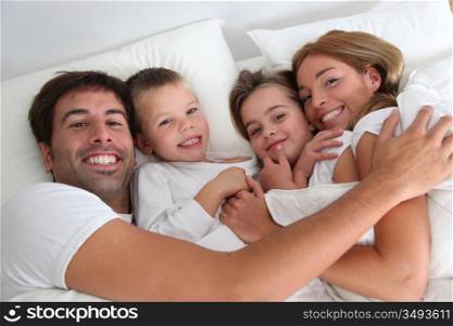 Family portrait laying in bed