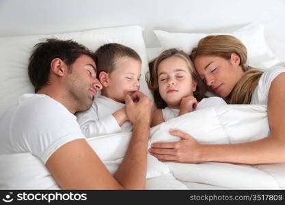 Family portrait laying in bed