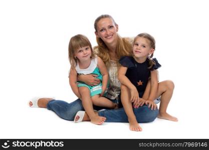 Family portrait of a young charming mother and two daughters, isolate on white background.