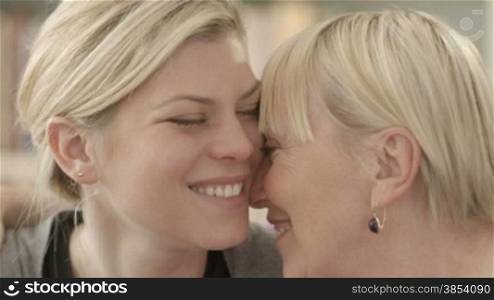 Family portrait of happy mom and daughter smiling, hugging, showing love and affection. Close-up, slow motion