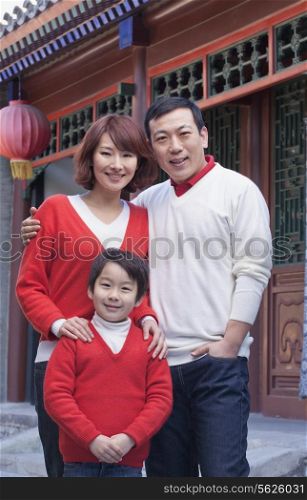 Family portrait outside by a traditional Chinese building