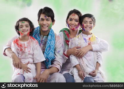 Family posing after playing holi