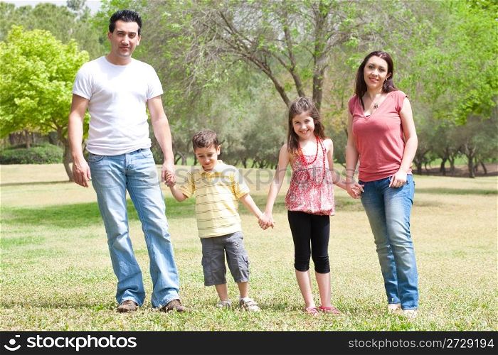 Family posing to camera in the park,outdoor