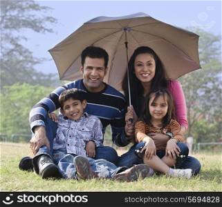 Family posing with an umbrella