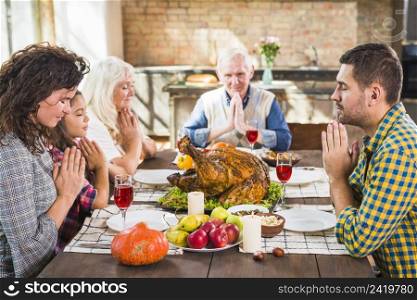 family praying before meals