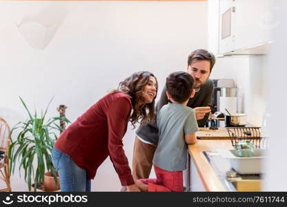 Family preparing and eating peanut chocolate cookies at home