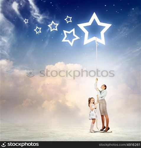 Family pulling rope with a star symbol. Image of young happy family pulling rope with a star symbol