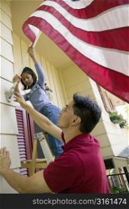 Family putting up an American flag