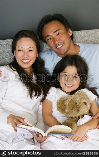 Family Reading in Bed Together