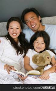 Family Reading in Bed Together