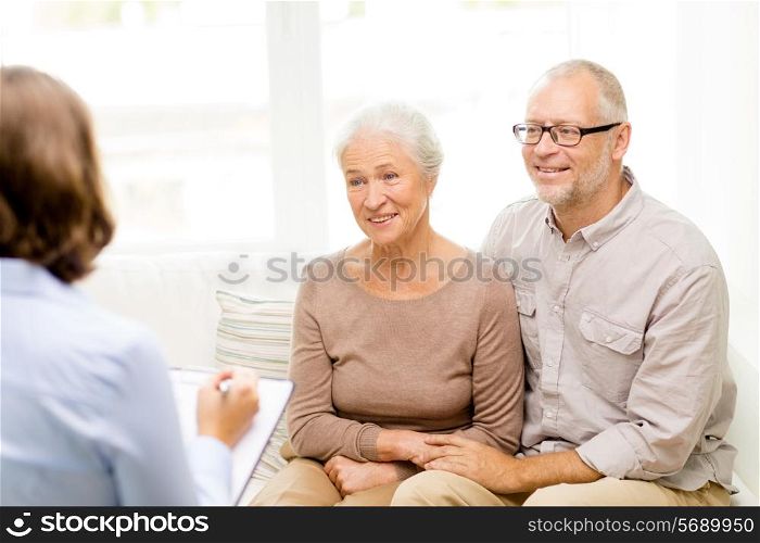 family, relations, age and people concept - happy senior couple and psychologist or social worker at home
