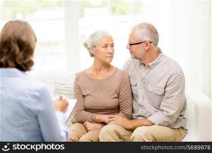 family, relations, age and people concept - senior couple and psychologist or social worker at home