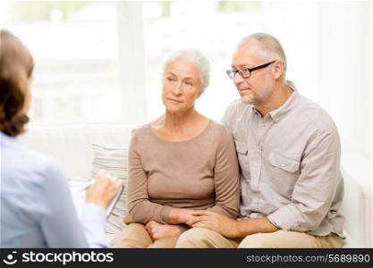 family, relations, age and people concept - senior couple and psychologist or social worker at home