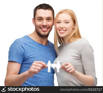 family, relationship and love concept - smiling coule holding paper family with heart